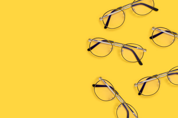 istock Border frame made of eyeglasses on a yellow background. 1267183533
