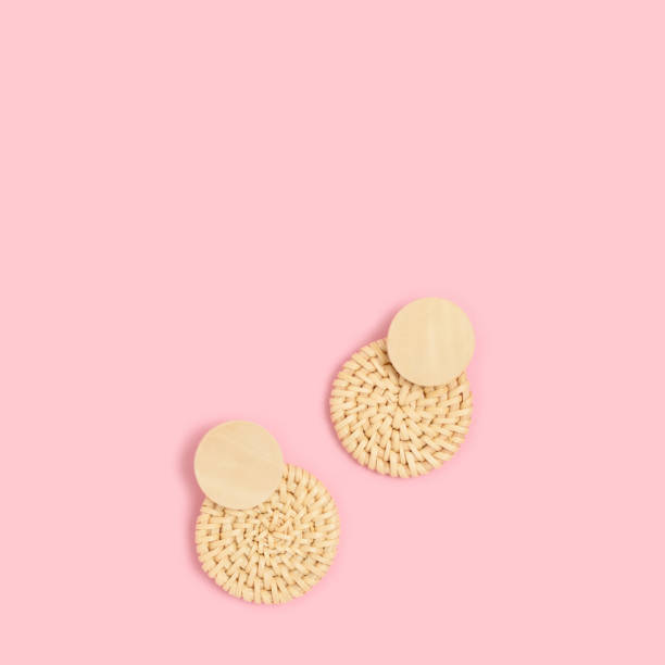 istock Wicker earrings on a pink pastel background. 1267184725
