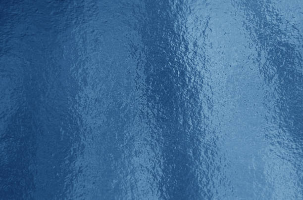 istock Blue foil background with highlights and uneven texture 1267184967