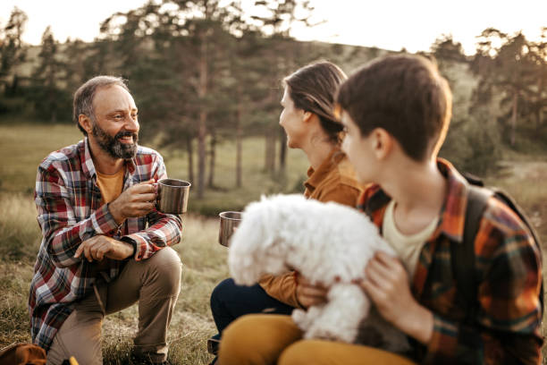 istock Family drinking coffee on hiking tour break 1267184985