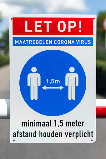 Eernewoude, The Netherlands. May 9th, 2020: Stay 4,9 feet apart social distancing guidelines for coronavirus COVID-19 on signboard in front of trail path hiking pathway sidewalk in park. As a request uploaded as creative stock. Logo and copyright info have been removed.