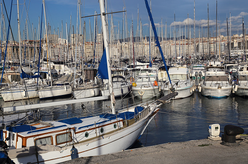 Yachts and sailboats and their reflections in the old port of Marseille, France