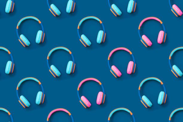 istock Seamless pattern of blue and pink colored headphones on blue background. 1267187046