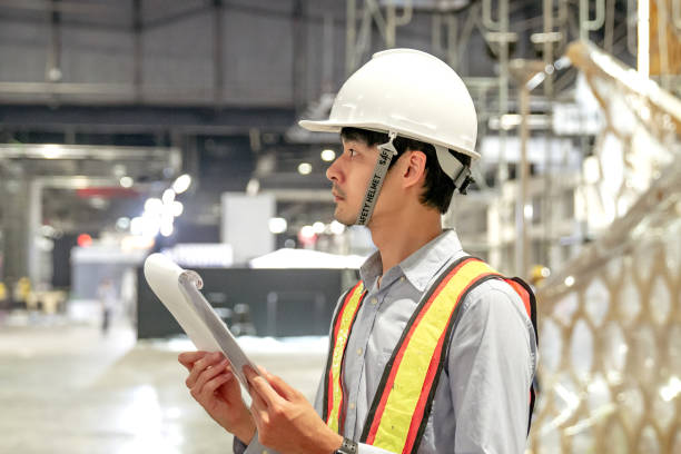 istock businessman working in factory. 1267188122