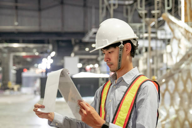 istock Male Industrial Engineers Look at Project. working on documents 1267188129