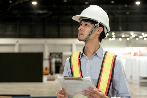 istock Male Industrial Engineers Look at Project. working on documents 1267188342