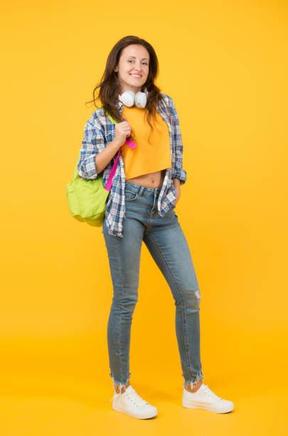 istock Brainy is new sexy. Happy student yellow background. University student carry backpack. Pretty student smile in casual wear. Senior high student. Girl back to school. University. Higher education 1267188557
