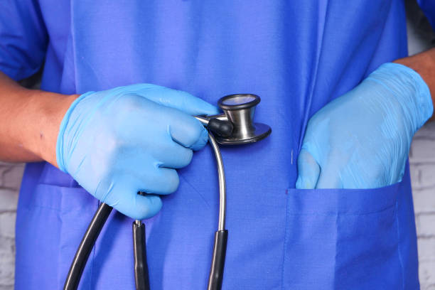 istock doctor hand in protective gloves holding stethoscope 1267188648