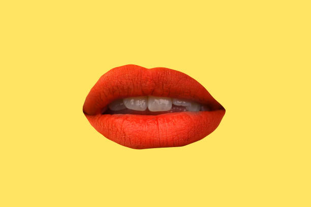 istock Woman's lips close up isolated on yellow background 1267189591