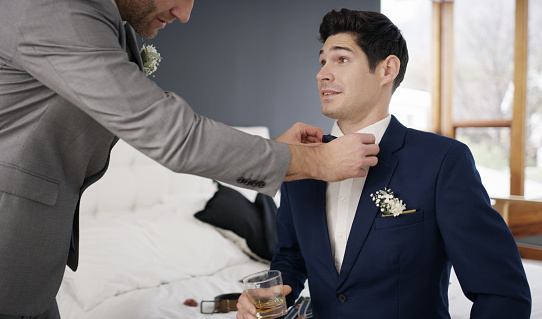 Shot of the groom and his best man getting ready in a room