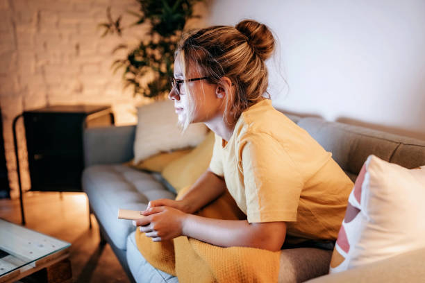 istock Young women watching tv at home 1267190537