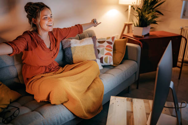 istock Young women watching tv at home 1267190733