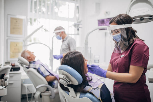 istock Man and woman at the dentist getting their teeth treated 1267190735