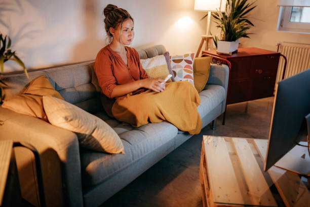 istock Young women watching tv at home 1267190760