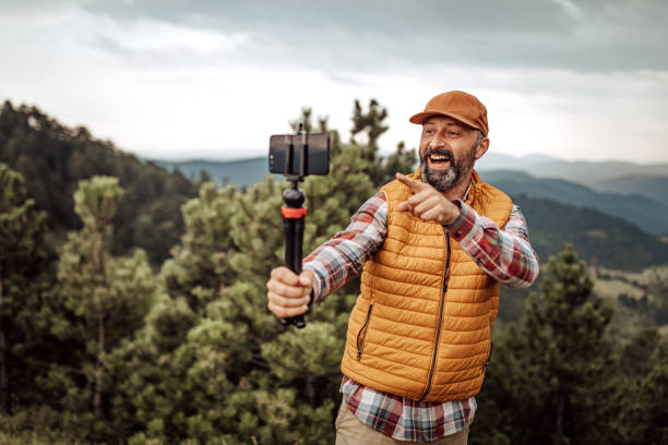 istock Man hiking and vlogging using mobile phone 1267191074