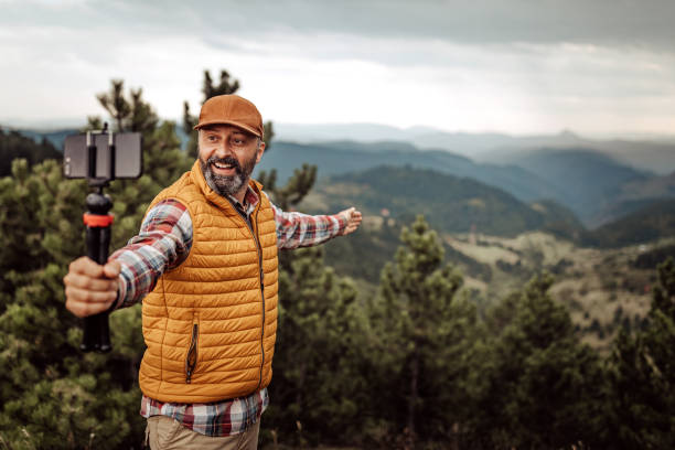 istock Man hiking and vlogging using mobile phone 1267191098