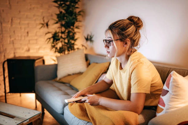 istock Young women watching tv at home 1267191940