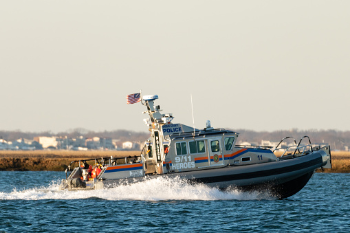 Long Island, New York USA - February 21, 2019 : A Nassau County Police Marine Patrol boat patrols the waterways of south Nassau County.