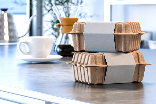 Cajas en blanco de papel o cartón reciclables con etiquetas en blanco en el interior moderno y elegante de la cocina. Entrega. Copiar espacio. Renderizado en 3D photo