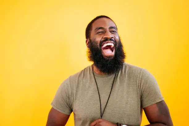 Photo of Candid studio shot of laughing 31 year old black man