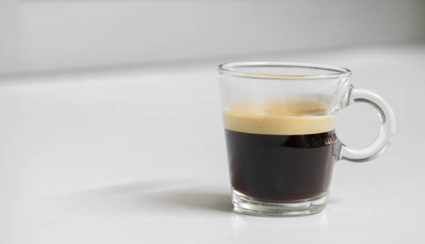 istock Newly brewed espresso coffee smelling fragrant and frothy places on a white table for a fresh, energy-rich starting to the day. 1267196241