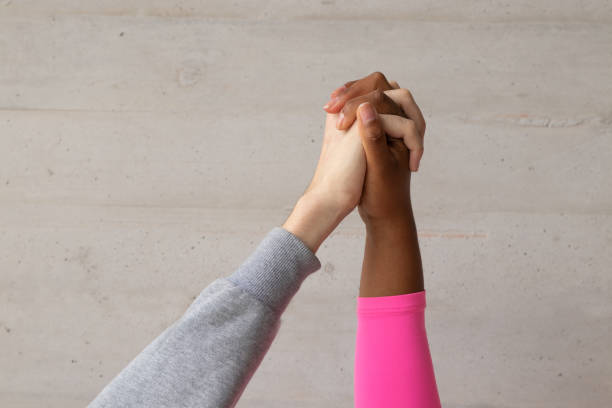 istock joined hands of different ethnic races, diversity 1267196715