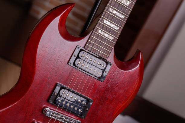 istock Body red electric guitar close-up 1267198812