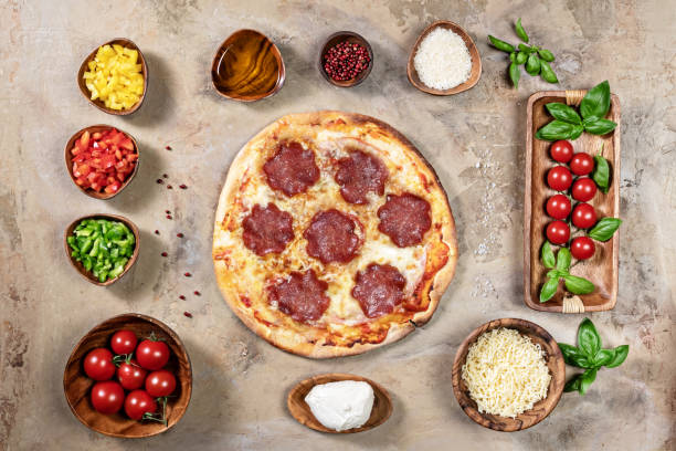istock Handmade pizza with bowls of ingredients 1267199517