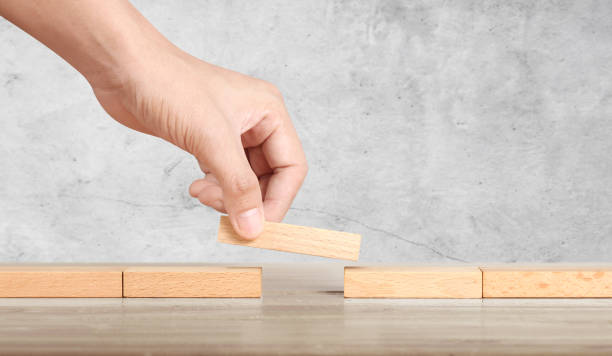 istock Hand liken person stepping up wood block stacking as step stair 1267200723