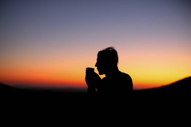istock A silhouette of a female drinking coffee during sunrise 1267203105