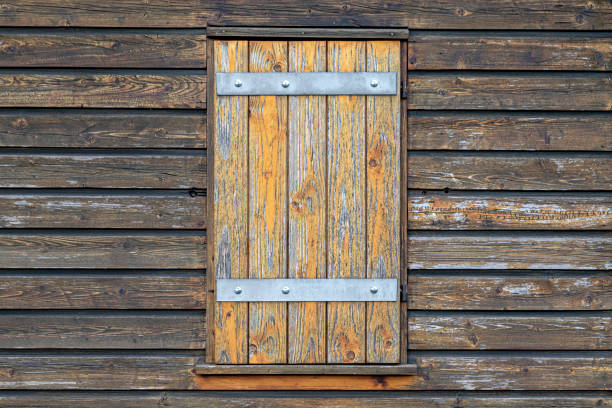 wall of wooden boards with a closed window, background