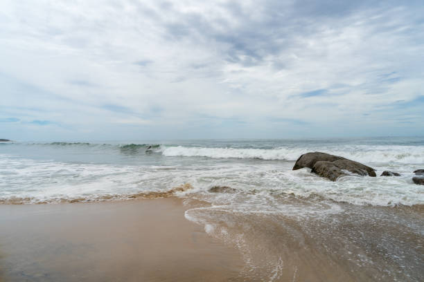 istock waves and large rocks on the beach 1267204413