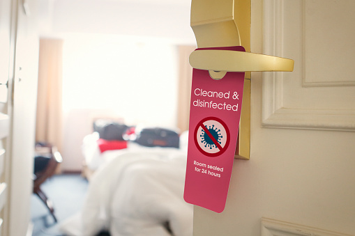 Hotel room cleaned and disinfected door tag with no covid19 sign
