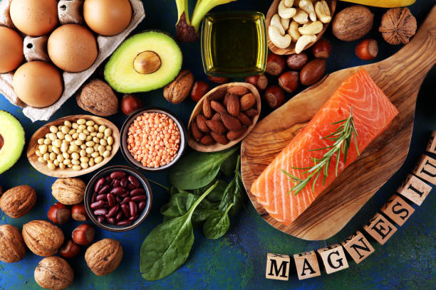 istock Products containing magnesium: bananas, almonds, avocado, nuts and spinach and eggs on background 1267207358