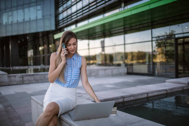 istock Happy business woman using mobile phone and working 1267208099