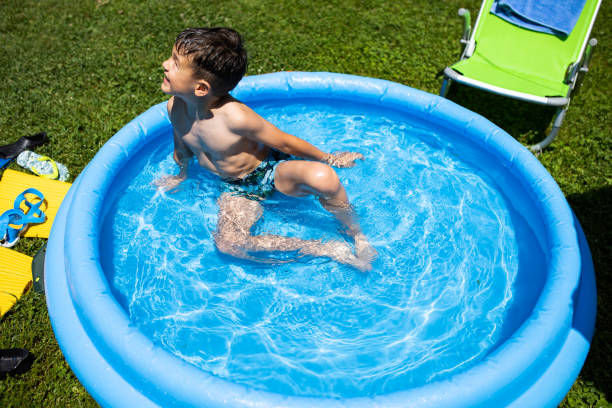 istock A cute boy in an inflatable pool 1267208353