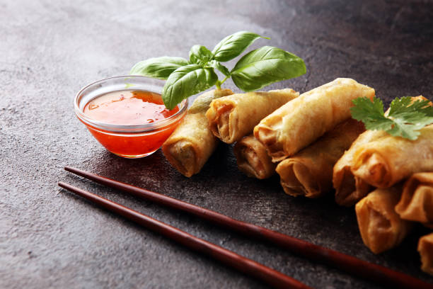 istock Fried chinese spring rolls with sweet chili sauce on rustic background 1267208390