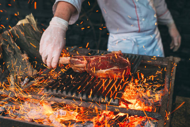 chef cooking steak. cook turns the meat on the fire. - steak meat barbecue grilled imagens e fotografias de stock