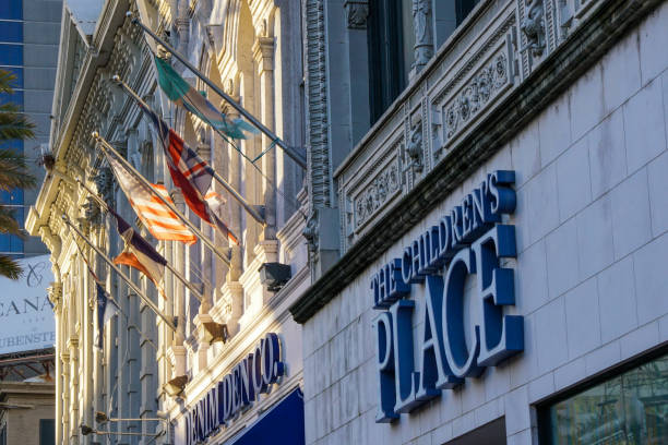 New Orleans - 04/15/2018 : Close up of old buildings in Canal Street with flags