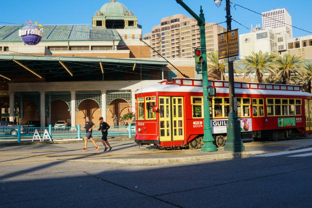 New Orleans - 04/15/2018 : runners and tram stop in front of Harrah's Casino, Canal Street