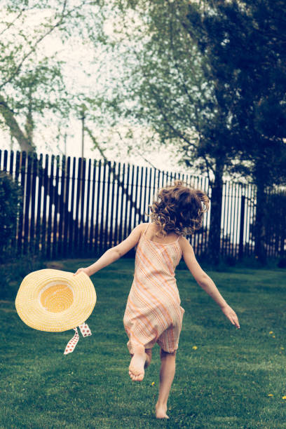 istock The child runs on the lawn in summer. 1267213960