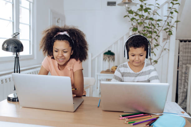 istock Cute brother and sister learning online at home 1267214014