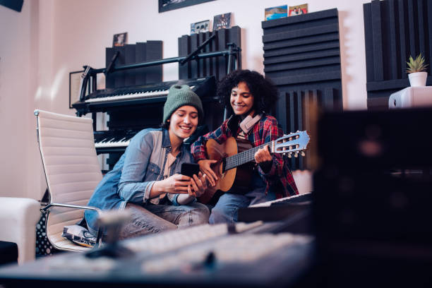 istock Two musicians using a mobile app for recording a song in the studio 1267215185