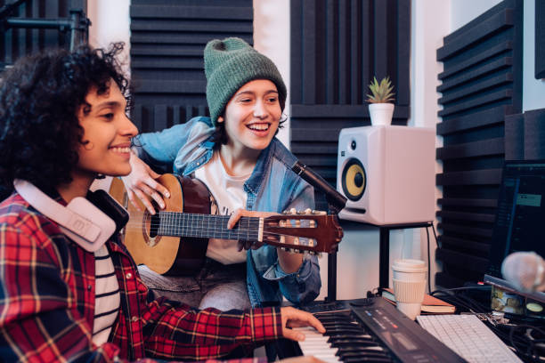 istock Two musicians cooperating and recording music in the studio 1267215188