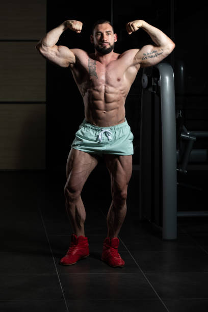 istock Muscular Men Is Hitting Rear Double Bicep Pose 1267217109
