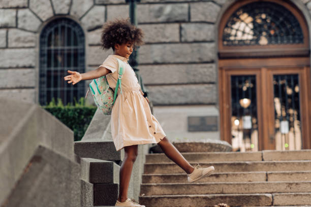 istock School girl playing in front of her school 1267218011