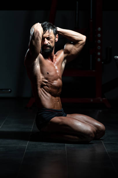 istock Serious Bodybuilder Sitting In The Gym 1267218141
