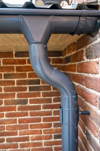 istock . Gutter system for a metal roof. Holder gutter drainage system on the roof. 1267218288