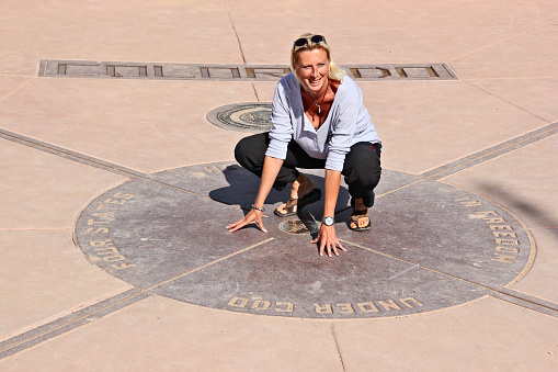 One woman touching the ground of four states at one time, Four Corners Monument