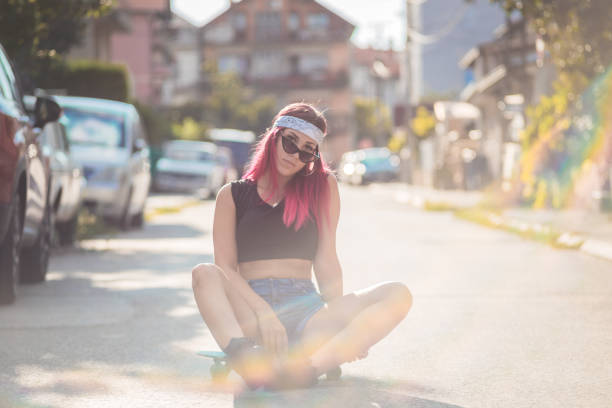 istock A beautiful young girl sitting on Penny board 1267224410